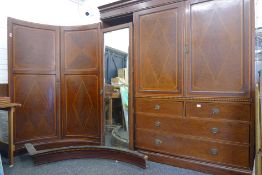 A Victorian inlaid compactum wardrobe with concave doors.