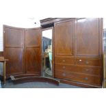 A Victorian inlaid compactum wardrobe with concave doors.