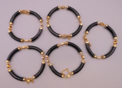 Five Chinese bracelets. Each approximately 21 cm long.