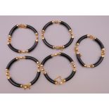 Five Chinese bracelets. Each approximately 21 cm long.