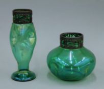 Two metal rimmed Art Nouveau green glass vases. The largest 24 cm high.