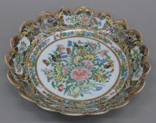 A 19th century Chinese porcelain Canton petal edged dish, painted with butterflies,