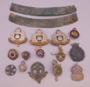 A quantity of military cap badges, etc.