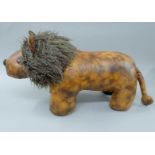 A leather footstool formed as a lion. 80 cm long.