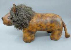 A leather footstool formed as a lion. 80 cm long.