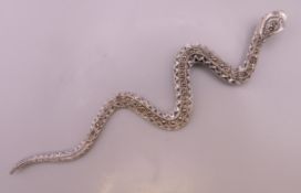 A silver marcasite snake form pendant. 12 cm long.