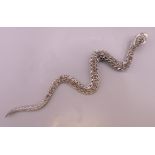 A silver marcasite snake form pendant. 12 cm long.