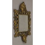 A brass framed mirror. 43 cm high.