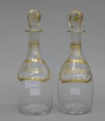 A pair of 19th century rum and brandy decanters with stoppers. Each 22.5 cm high.