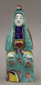 An 18th century Chinese porcelain figure of Guanyin painted in bright enamels. 21 cm high.