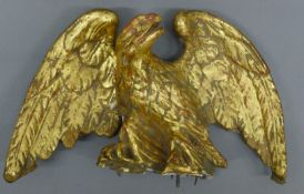 A gilt eagle surmount. 23 cm wide.