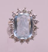 An 18 ct gold aquamarine and diamond ring. Ring size M/N.