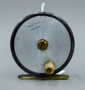 A 2 5/8'' diameter Foster of Ashbourne trout fly reel, alloy with brass foot and horn handle.