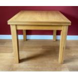 A modern oak extending flip-top dining table. 90 cm square when closed.