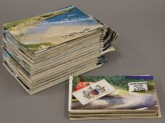 A quantity of vintage postcards, including two silk examples.