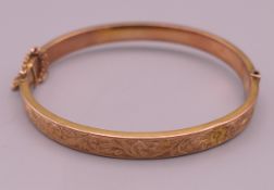 A 9 ct gold bangle form bracelet. 5.75 cm internal diameter. 8 grammes.