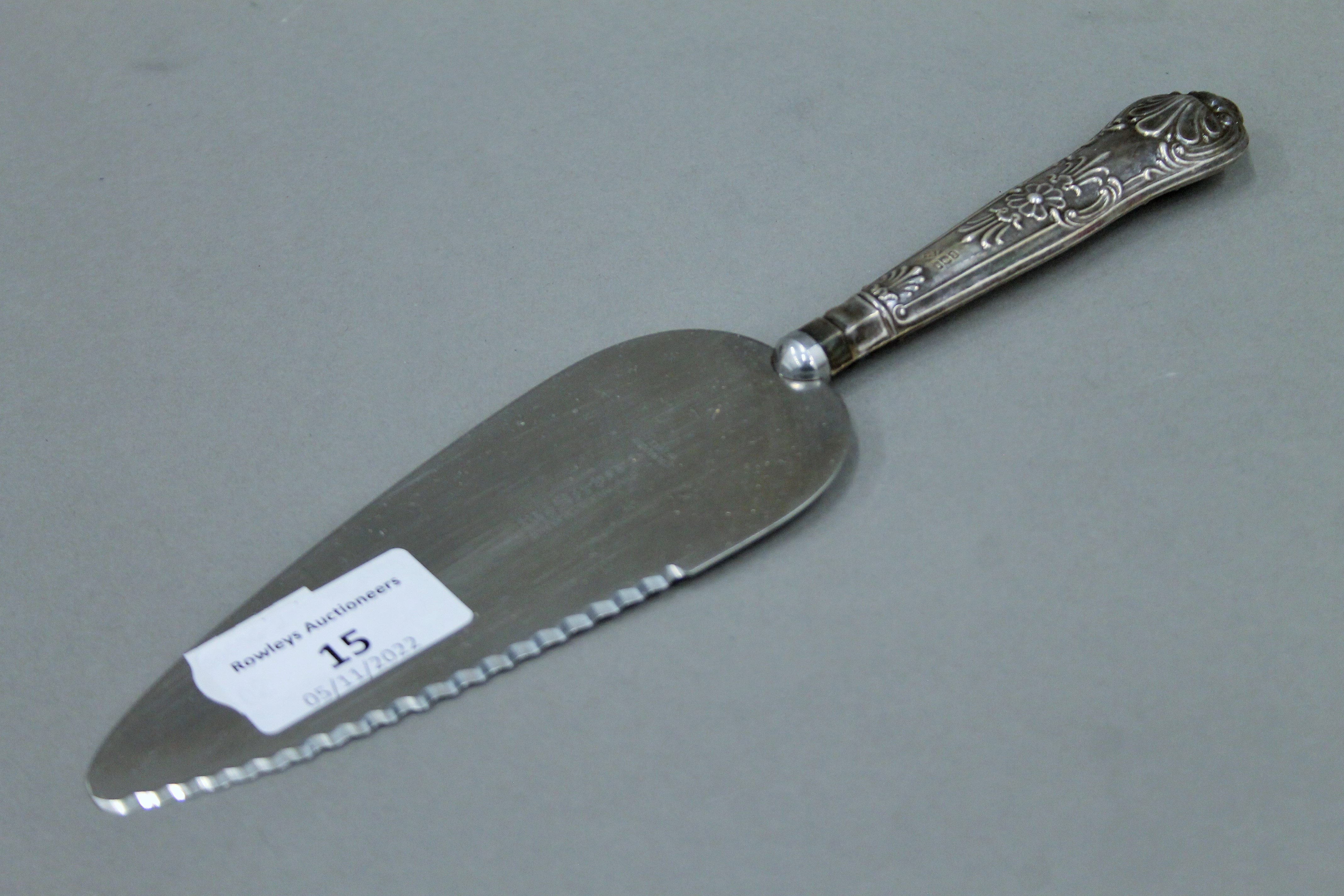 A silver handled cake knife.