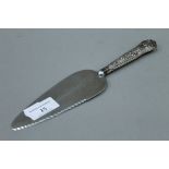 A silver handled cake knife.