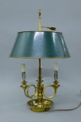 A three light brass lamp with toleware shades. 54 cm high.