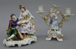 Two Continental porcelain figures, one mounted as a candelabra. The largest 24 cm high.