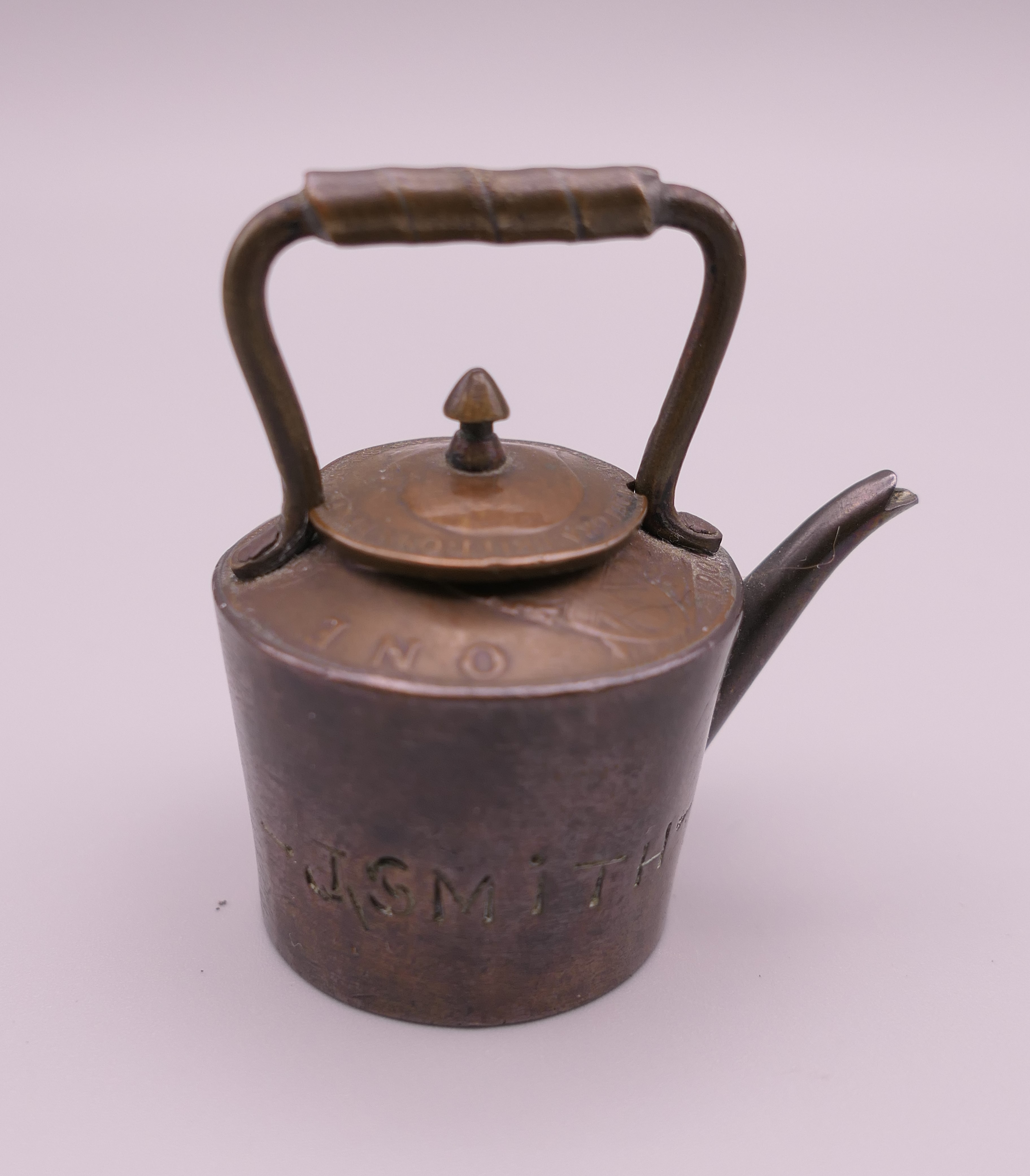 A doll's house copper kettle, made from old copper coins. 5 cm high.