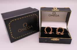 A boxed pair of modern Omega cufflinks. 1.75 x 1.75 cm.