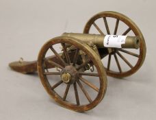 A wood and brass model of a field cannon. 20 cm long.