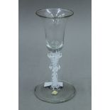 An 18th/19th century double knopped air twist stem glass. 16 cm high.