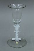 An 18th/19th century double knopped air twist stem glass. 16 cm high.