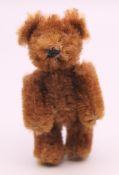 A Schuco miniature teddy bear. 7 cm high.