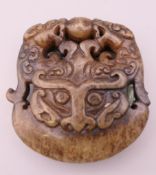 An archaic style jade pendant. 5 cm wide.