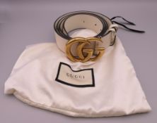 A Gucci cream leather belt in a Gucci fabric bag. Buckle 7.