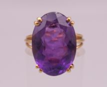 An unmarked gold amethyst ring (tests as 15 ct plus gold). Ring size M. 5 grammes total weight.