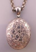 A silver locket 1903 Birmingham on a silver chain.