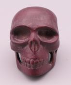 A small model of a skull. 3.5 cm high.