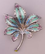 A silver enamel leaf form brooch. 6 cm high.