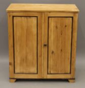 A 19th century pine two door cupboard. 81 cm wide.