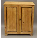 A 19th century pine two door cupboard. 81 cm wide.