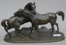 A bronze model of two horses, signed P J Mene. 33 cm long.