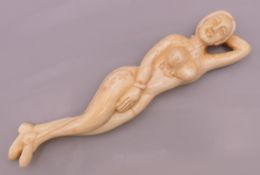 A carved bone medical figure. 13 cm long.