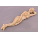 A carved bone medical figure. 13 cm long.