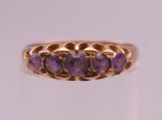 A 9 ct gold and amethyst ring. Ring size N. 1.8 grammes total weight.