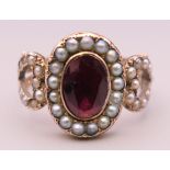 A Georgian unmarked gold, seed pearl and garnet ring. Ring size N.