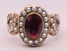 A Georgian unmarked gold, seed pearl and garnet ring. Ring size N.