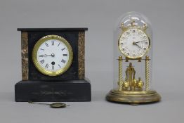 A marble mantle clock and an anniversary clock. The former 20 cm high.