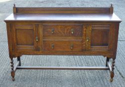 An early 20th century oak side board with barley twist legs. 151 cm wide, 47.5 cm deep.