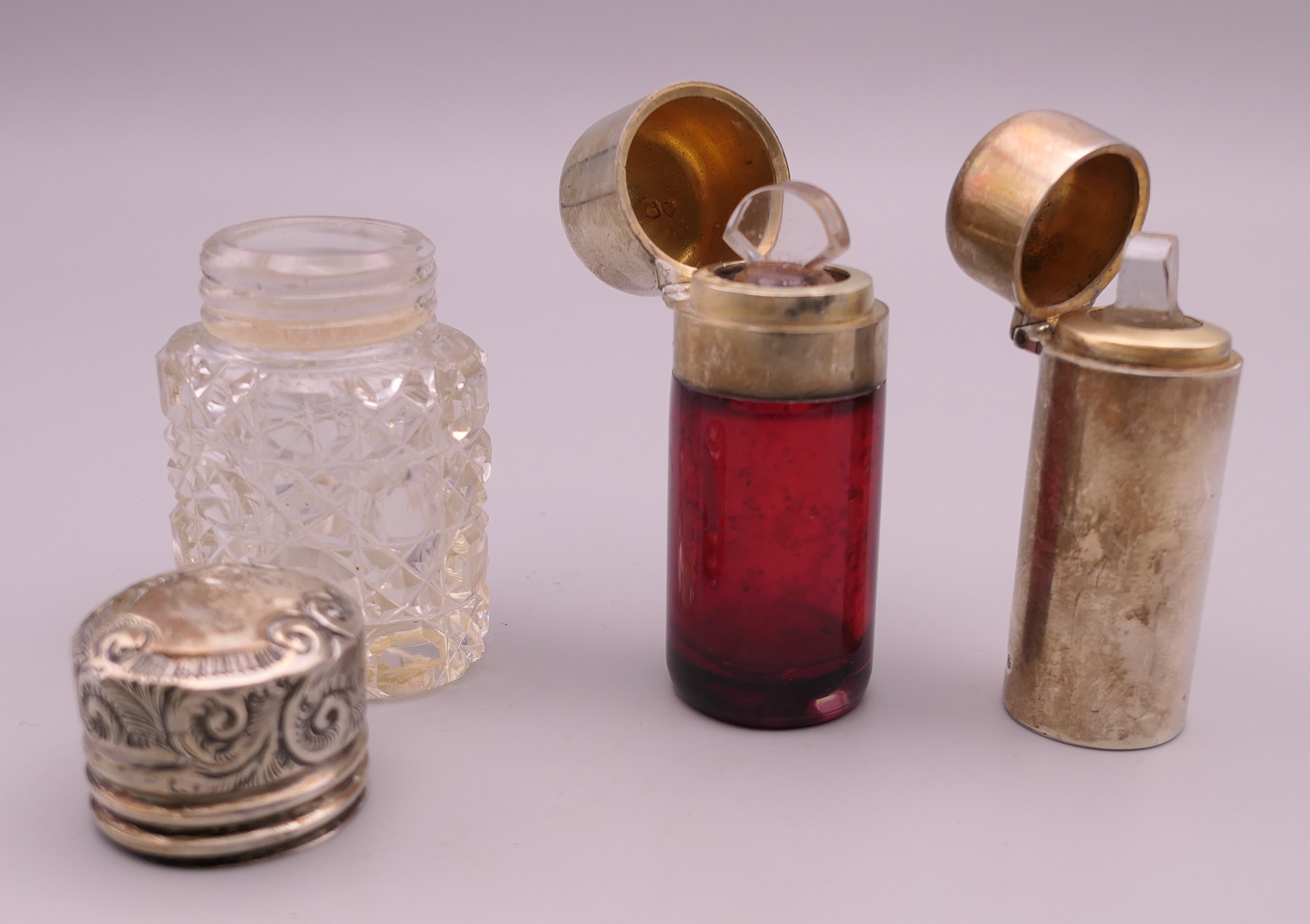 A silver clad scent bottle and two silver lid bottles. Tallest 6.25 cm high. - Image 2 of 6