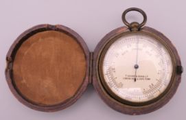 A T Cooke & Sons Ltd pocket barometer, in leather case. 5 cm diameter.