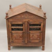 An Eastern hardwood and metal mounted hutch/dog house. 85 cm high.