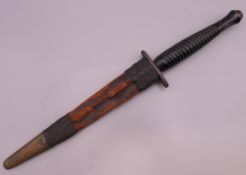 An unmarked Fairbairn Sykes Commando dagger in sheath.